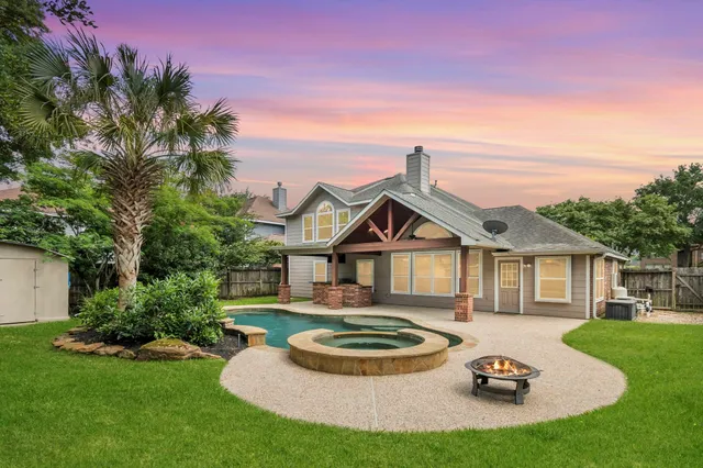 a front view of a house with a garden and plants