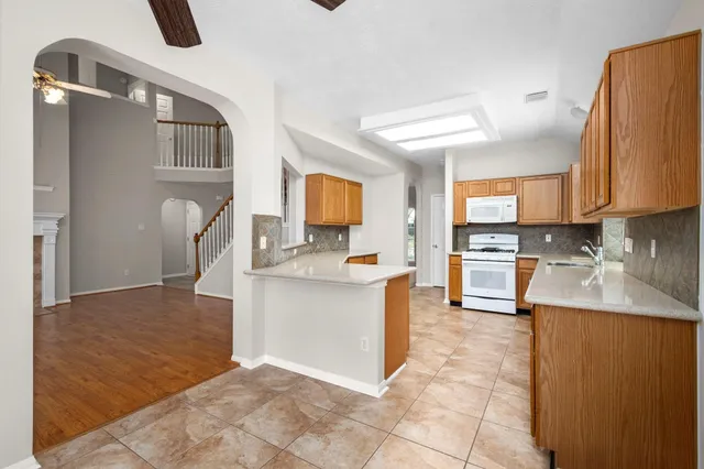 a large kitchen with cabinets and stainless steel appliances