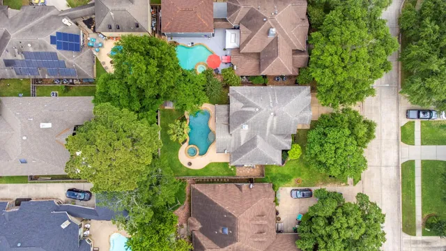 an aerial view of a house with a yard and garden
