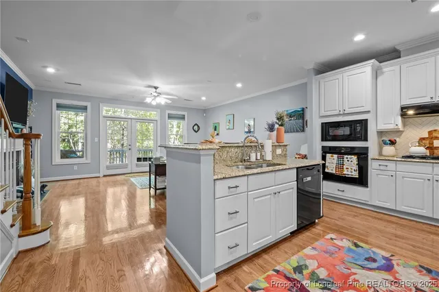 a kitchen with stainless steel appliances granite countertop a refrigerator and a stove top oven