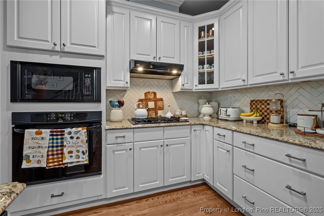 47 Abernathy Drive, Unit 13 Chapel Hill, NC 27517 - Photo 14 of 46 a kitchen with granite countertop cabinets stainless steel appliances and wooden floor