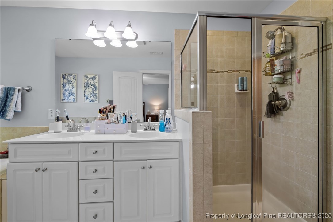 47 Abernathy Drive, Unit 13 Chapel Hill, NC 27517 - Photo 25 of 46 a bathroom with a double vanity sink mirror and shower
