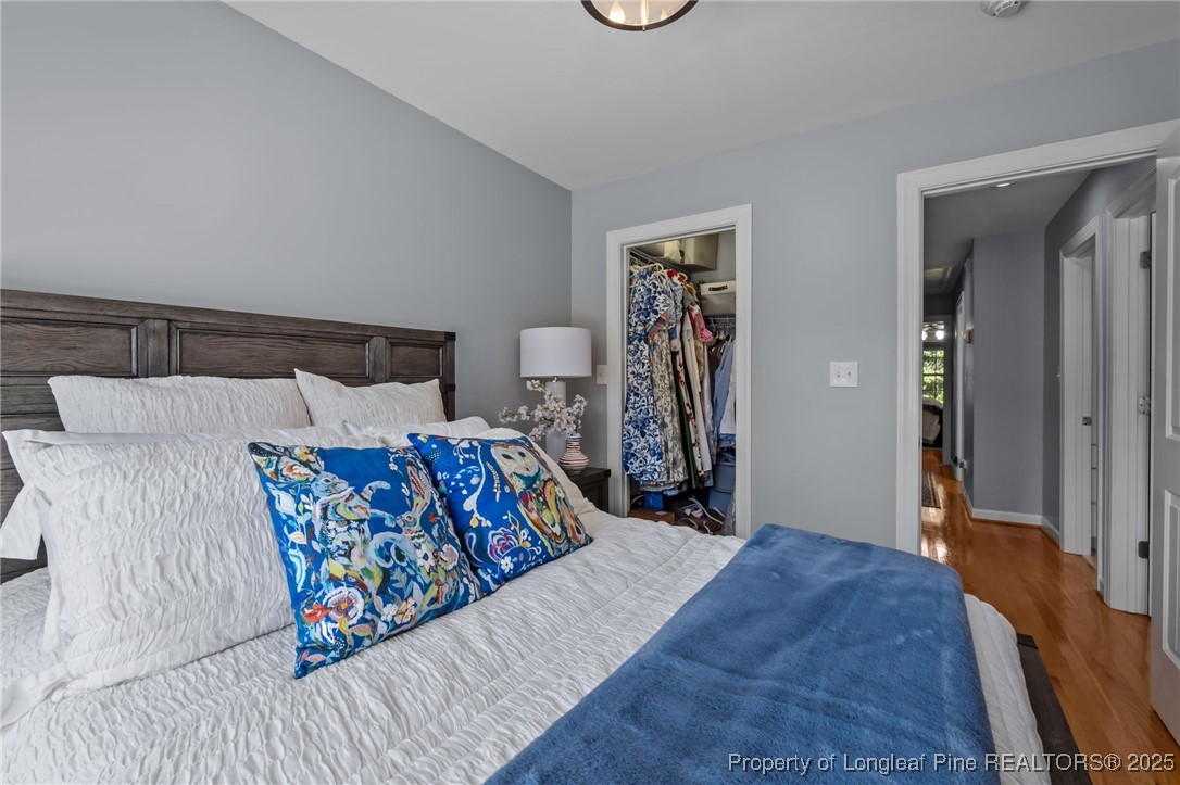 47 Abernathy Drive, Unit 13 Chapel Hill, NC 27517 - Photo 30 of 46 a bed sitting in a bedroom and painting on the wall