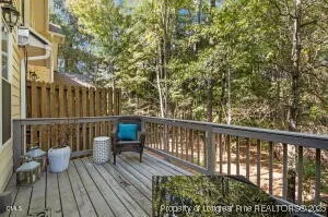 a view of a chair and table in the back yard of the house