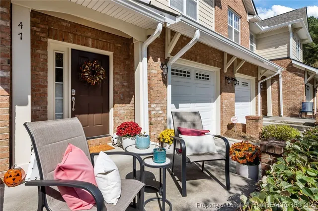 a view of a workspace with furniture and wooden floor