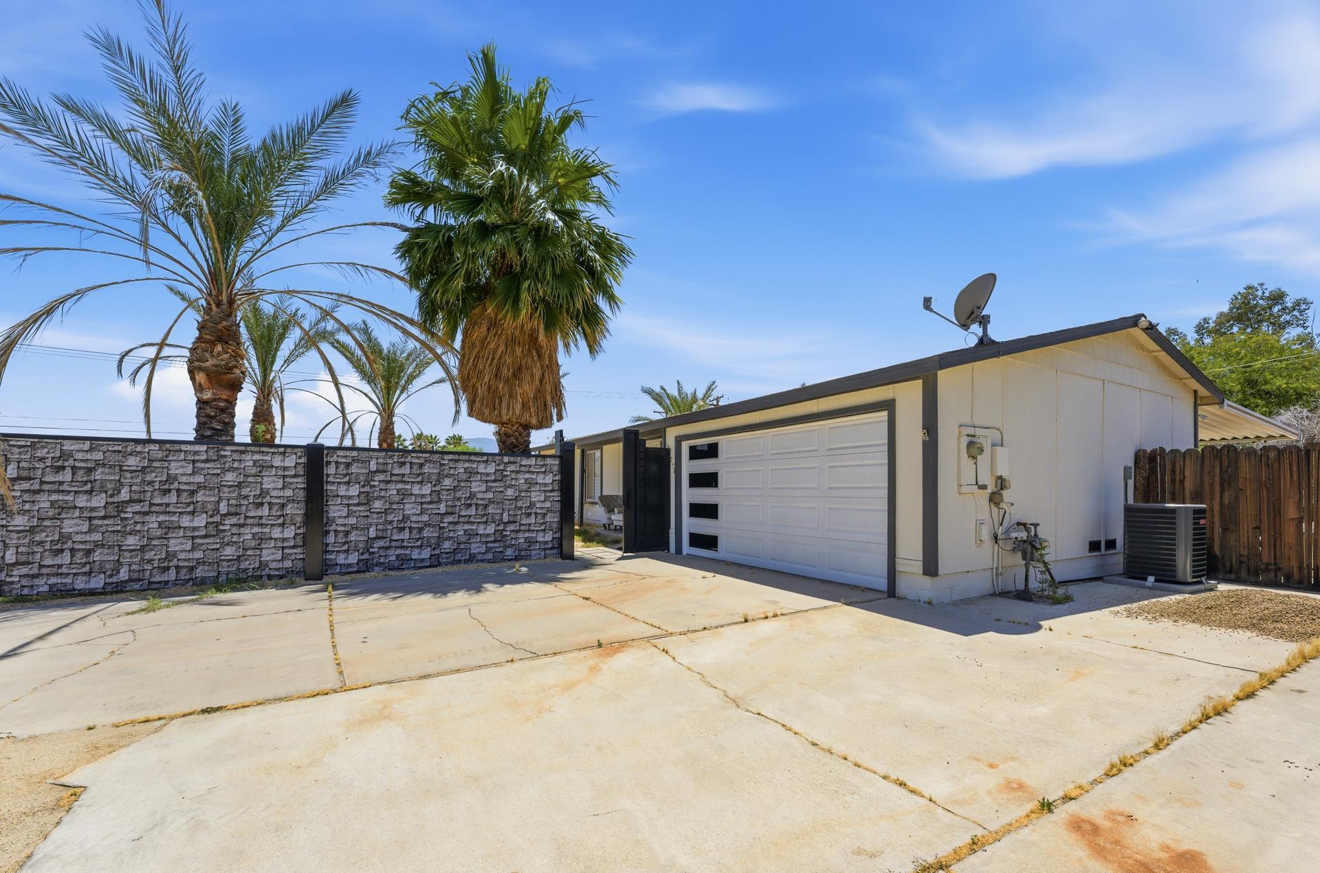 40961 Cecina Way Bermuda Dunes, CA 92203 - Photo 2 of 27 a view of a house with a garage