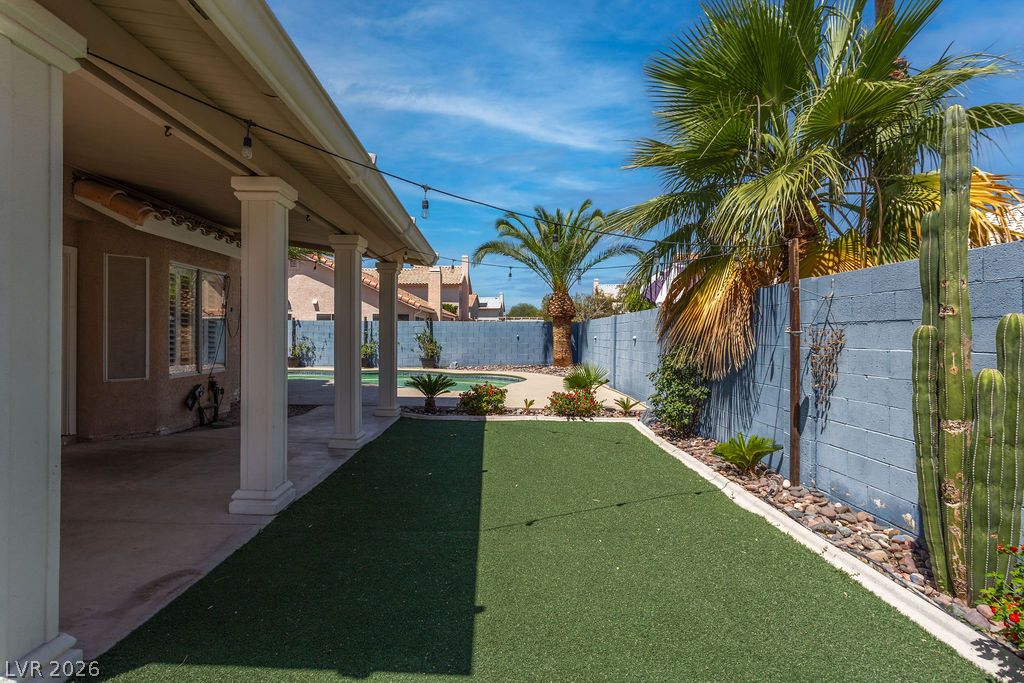 1416 Walstone Road North Las Vegas, NV 89031 - Photo 42 of 47 Lush synthetic lawn and a refreshing pool define this inviting outdoor living space.