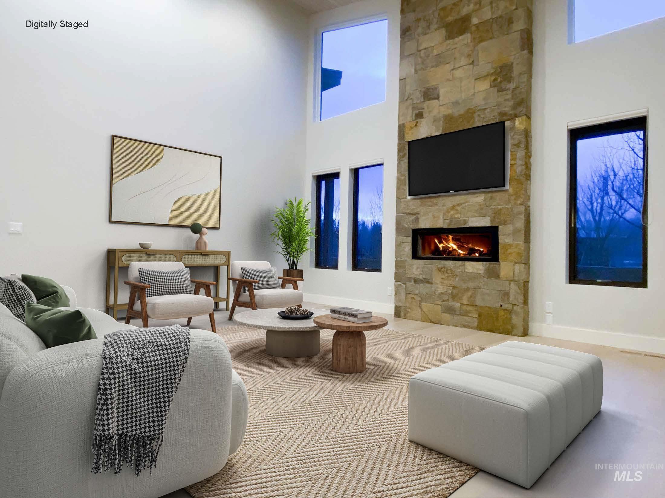 27 Streamside Drive Hailey, ID 83333 - Photo 2 of 39 DIGITALLY STAGED - Living room with a towering ceiling and a large fireplace