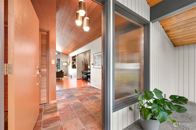 a view of a hallway with dining area