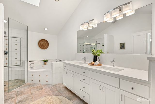a bathroom with a sink a light fixture and a mirror