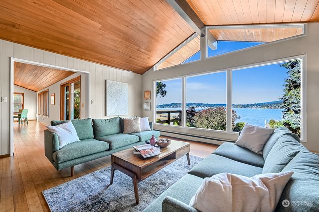 a living room with furniture a rug and a table