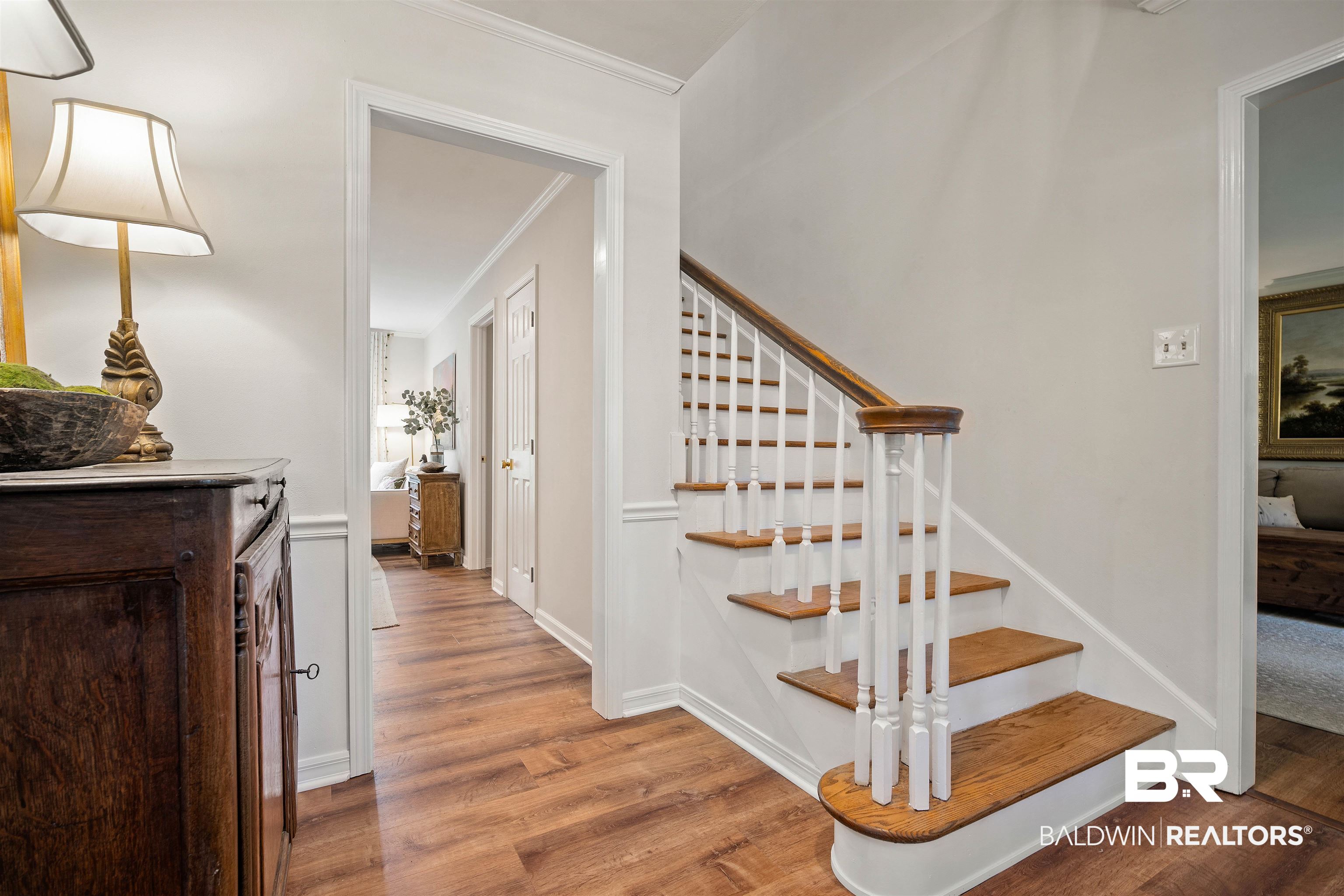 700 Eliza Jordan Road North Mobile, AL 36608 - Photo 12 of 44 Staircase featuring wood finished floors and crown molding