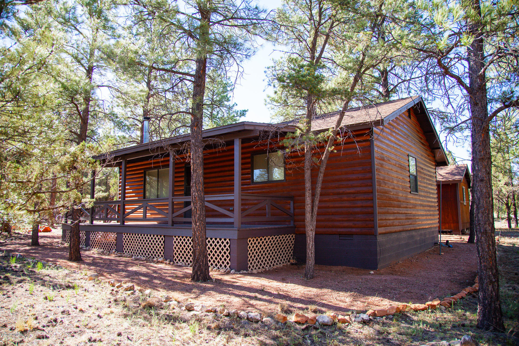 3112 Chevelon Road Overgaard, AZ 85933 - Photo 1 of 18 a view of a house with a tree beside of yard