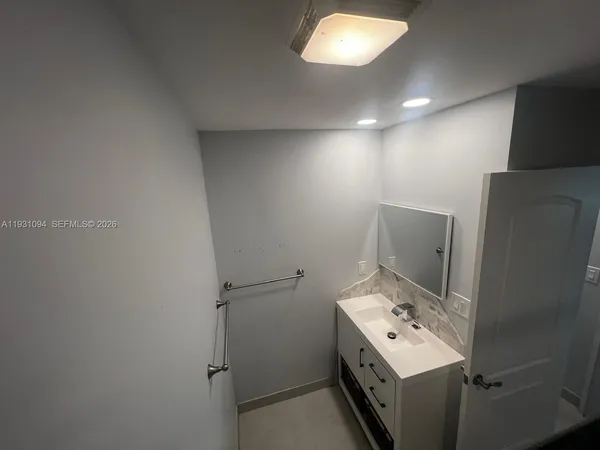 a bathroom with a sink a toilet and mirror