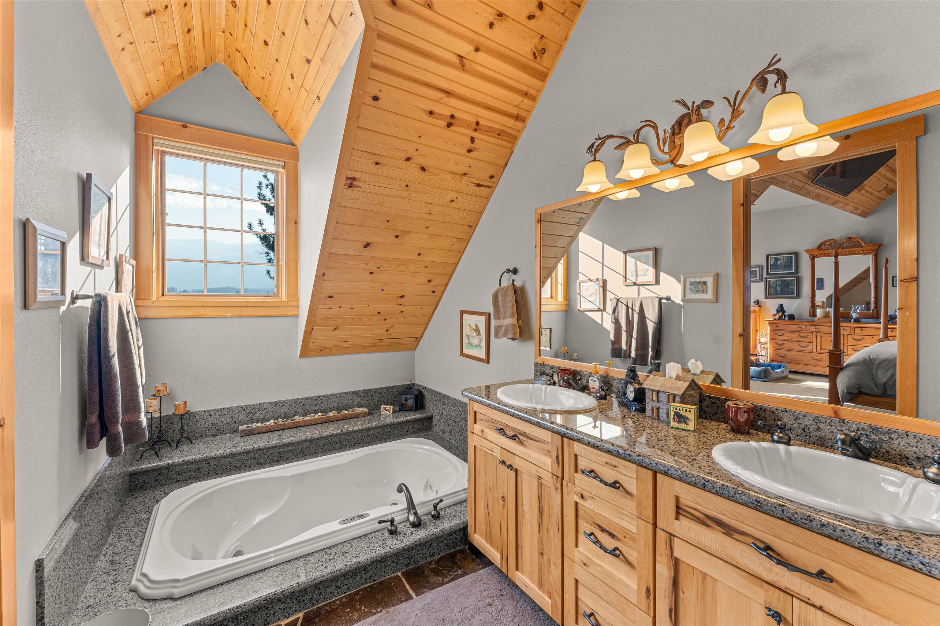 440 Valley Ranch Drive Clio, CA 96106 - Photo 16 of 50 a bathroom with a sink a mirror and a bathtub next to a window