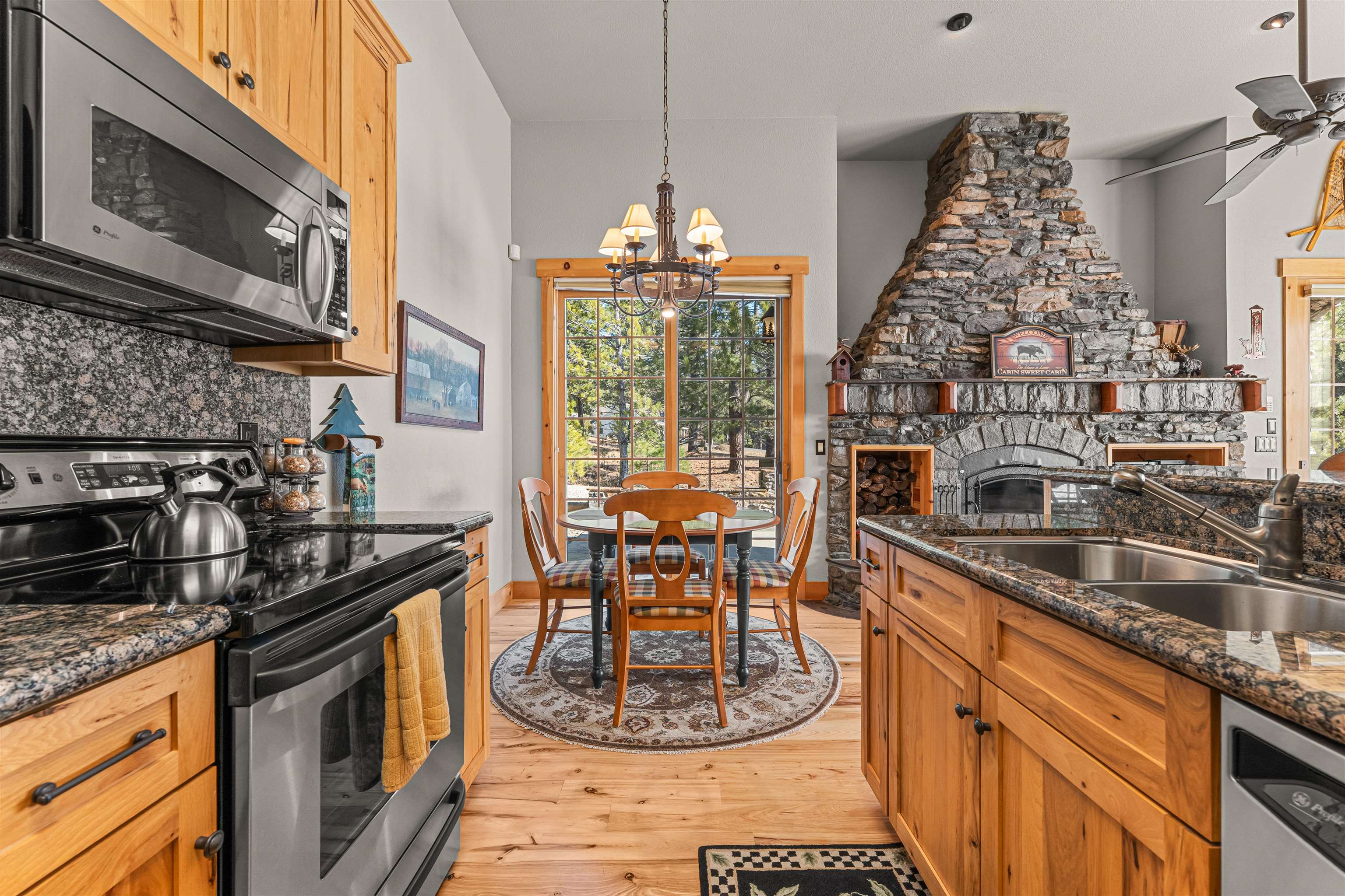 440 Valley Ranch Drive Clio, CA 96106 - Photo 25 of 50 a kitchen with stainless steel appliances granite countertop a stove a sink and a microwave