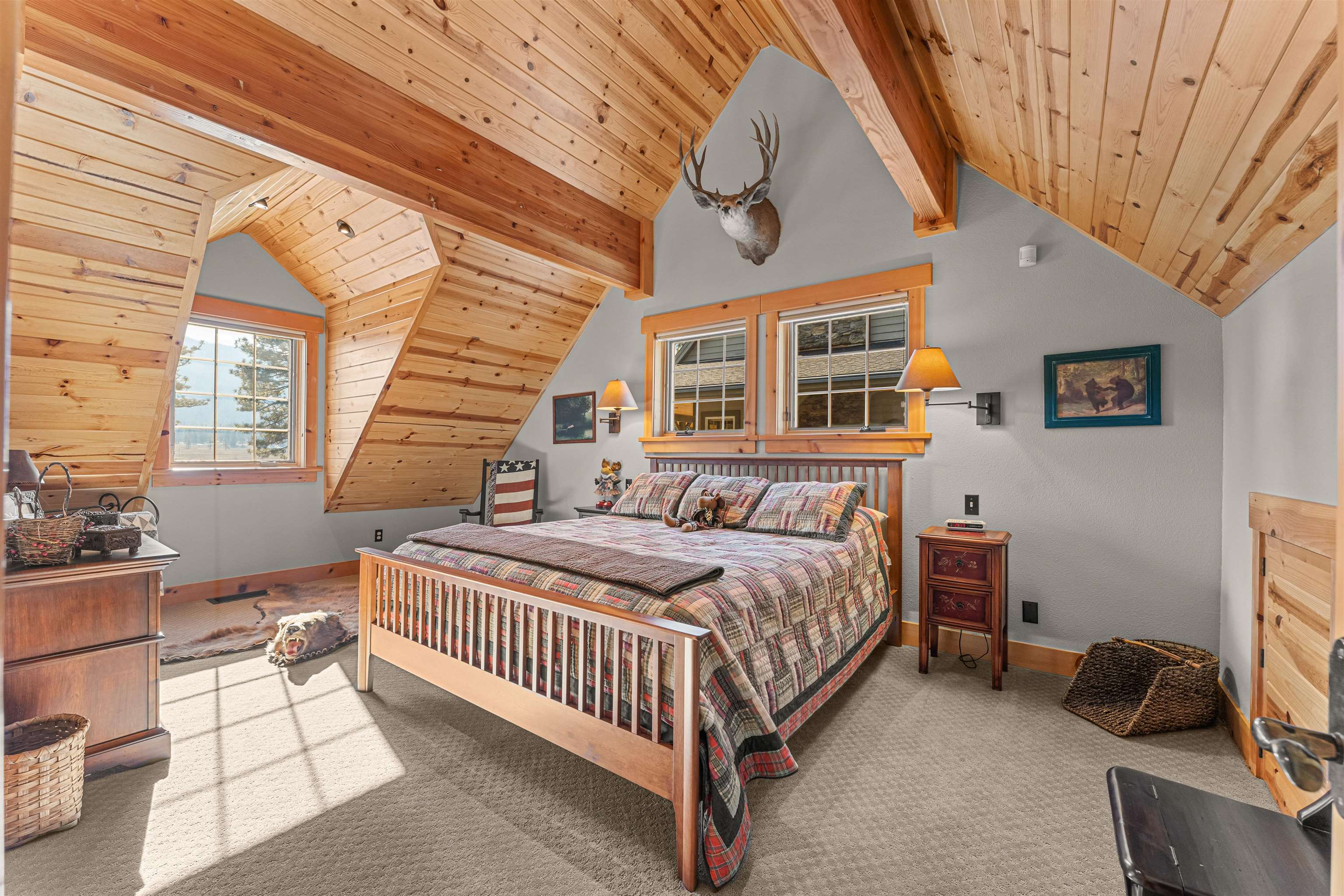 440 Valley Ranch Drive Clio, CA 96106 - Photo 30 of 50 a bedroom with a bed and a chandelier