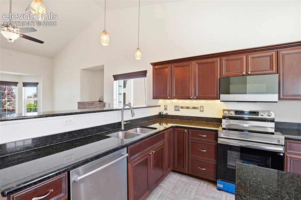 7806 Dutch Loop Colorado Springs, CO 80925 - Photo 8 of 41 a kitchen with a sink stove and cabinets