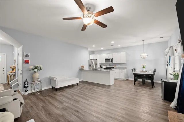 a living room with furniture and kitchen view