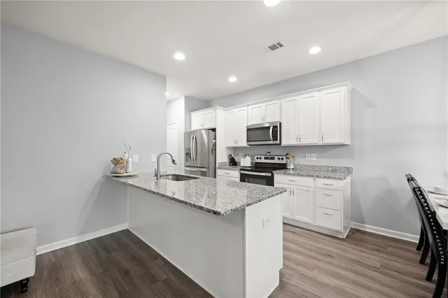 a kitchen with appliances cabinets and a sink