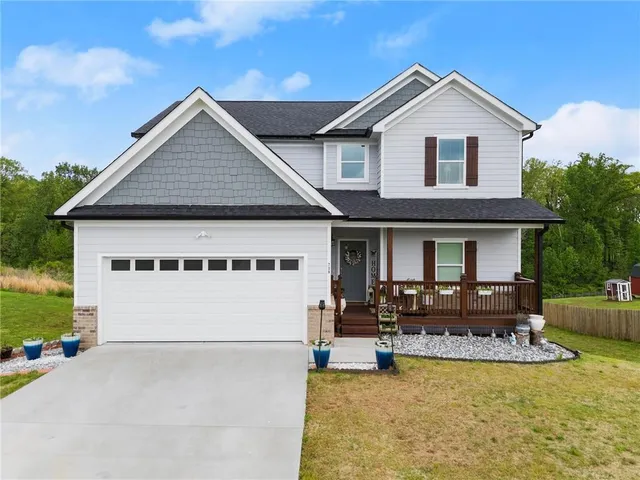 a front view of a house with swimming pool and furniture