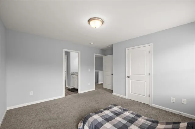 a en suite bathroom with a granite countertop sink and a mirror