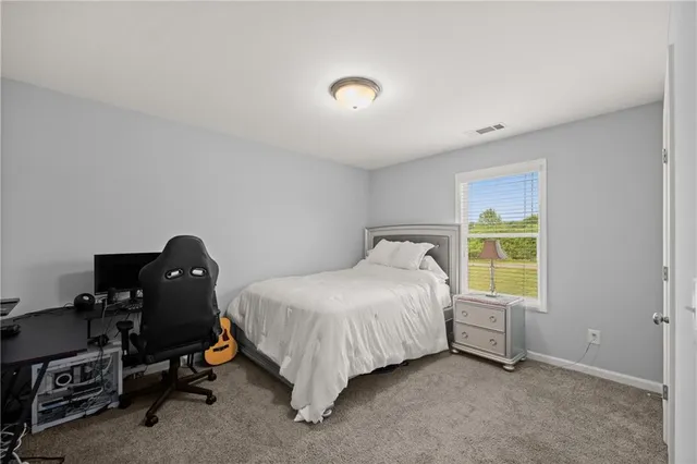 a bedroom with a bed and a lamp