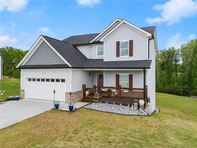 a view of a house with a yard and balcony