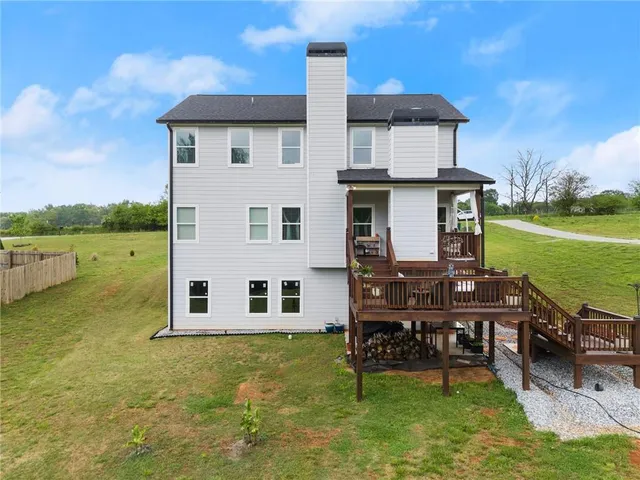 a view of a house with backyard porch and sitting area