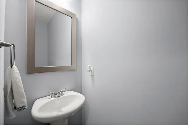 a bathroom with a sink a mirror and a toilet