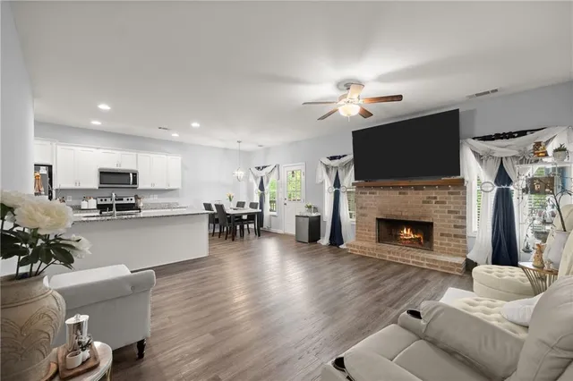 a living room with furniture a fireplace and a flat screen tv