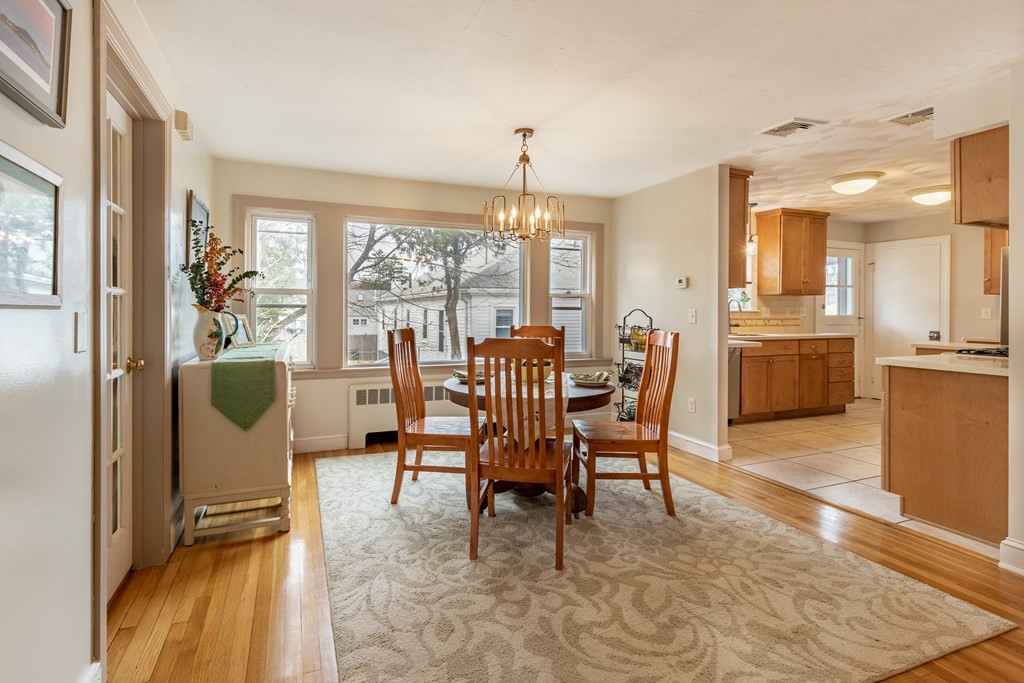 107 Oliver Road Waban, MA 02468 - Photo 12 of 32 a dining room with furniture a chandelier and fireplace