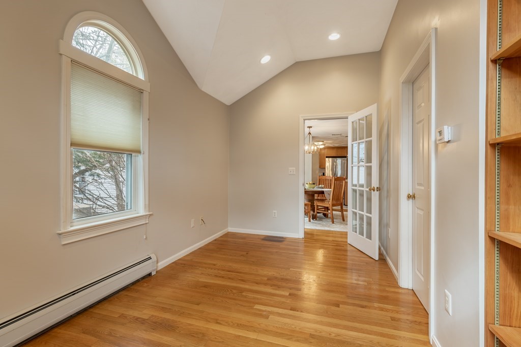 107 Oliver Road Waban, MA 02468 - Photo 17 of 32 a view of a hallway to a room with wooden floor and closet