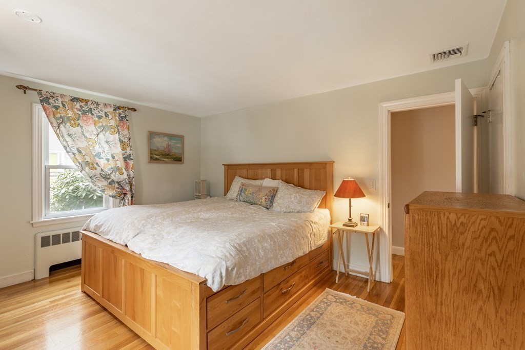 107 Oliver Road Waban, MA 02468 - Photo 19 of 32 a bed sitting in a bedroom next to a window