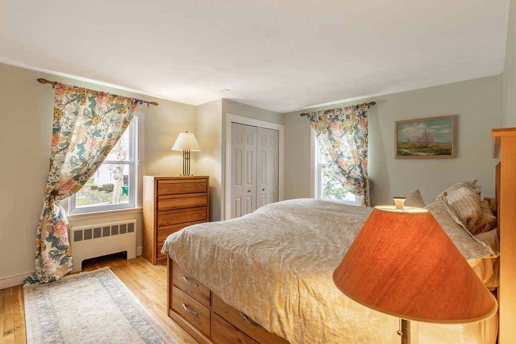 107 Oliver Road Waban, MA 02468 - Photo 20 of 32 a bedroom with a bed and a painting on the wall