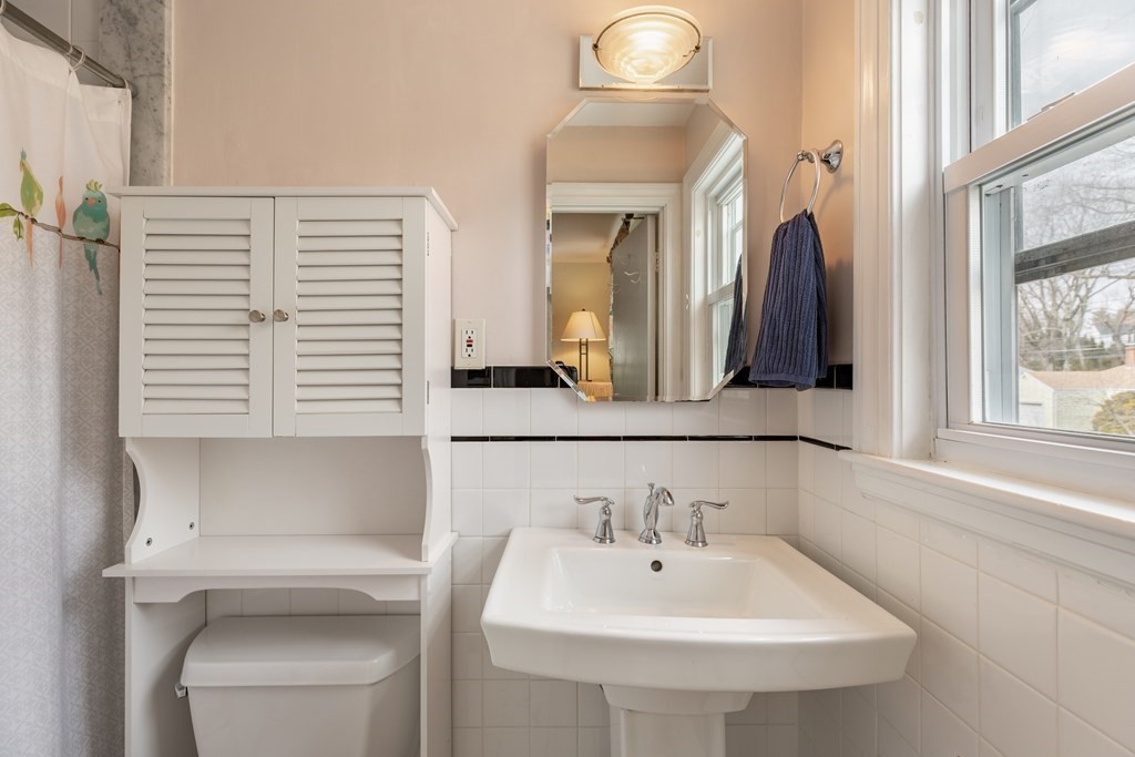 107 Oliver Road Waban, MA 02468 - Photo 21 of 32 a bathroom with a sink and a mirror
