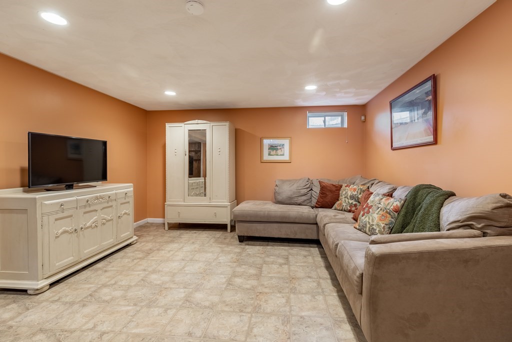 107 Oliver Road Waban, MA 02468 - Photo 25 of 32 a living room with furniture and a flat screen tv