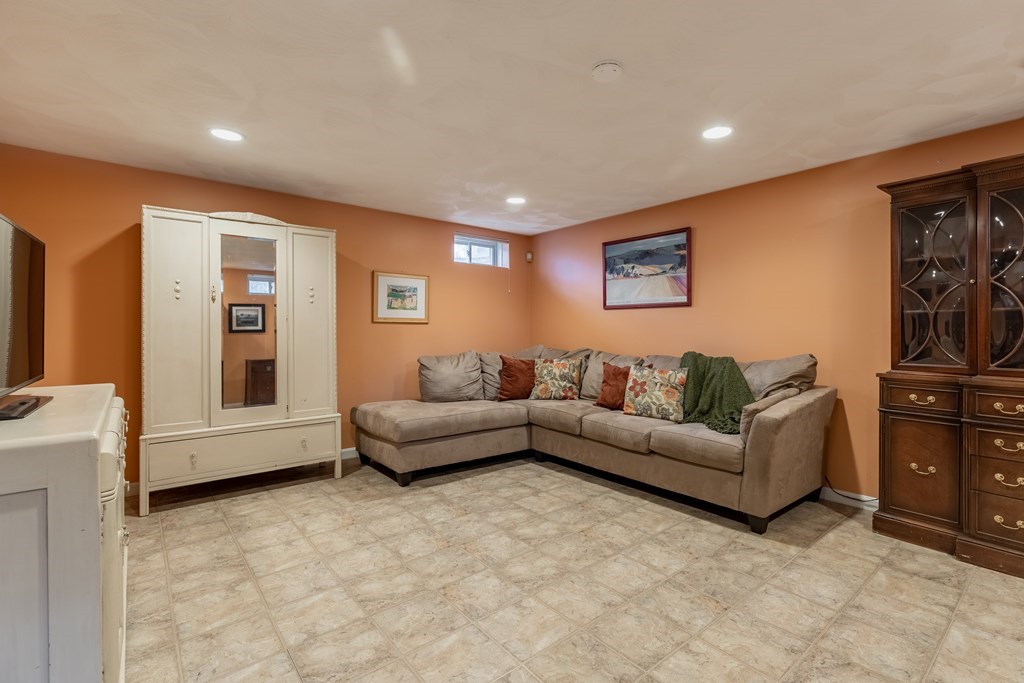 107 Oliver Road Waban, MA 02468 - Photo 26 of 32 a living room with furniture and a flat screen tv