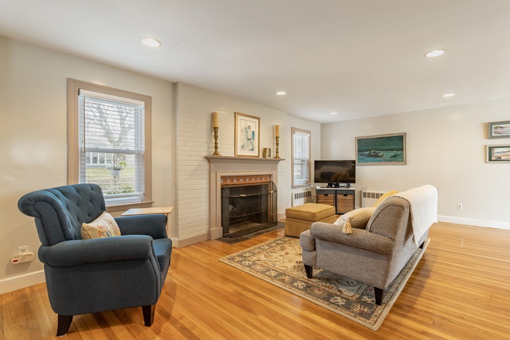 107 Oliver Road Waban, MA 02468 - Photo 6 of 32 a living room with furniture and a fireplace