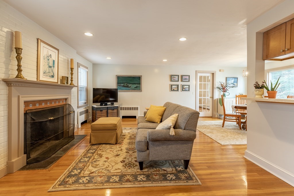 107 Oliver Road Waban, MA 02468 - Photo 7 of 32 a living room with furniture and a fireplace