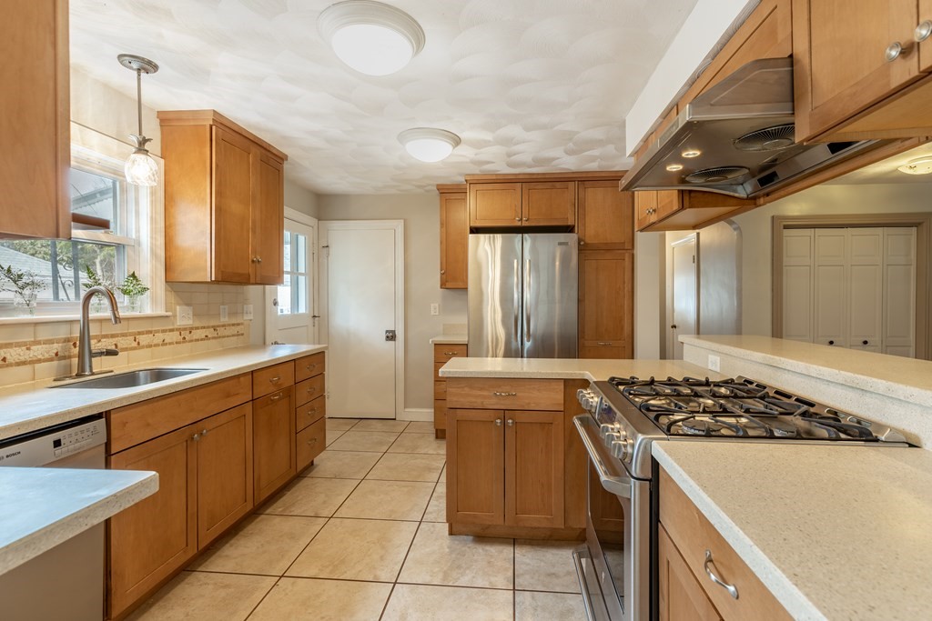 107 Oliver Road Waban, MA 02468 - Photo 10 of 32 a kitchen with a sink a stove and a refrigerator