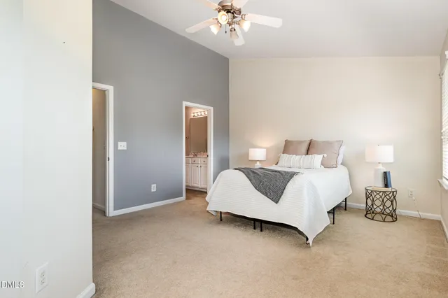 a bedroom with a large bed and a chandelier