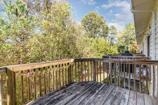 a balcony with wooden floor and fence