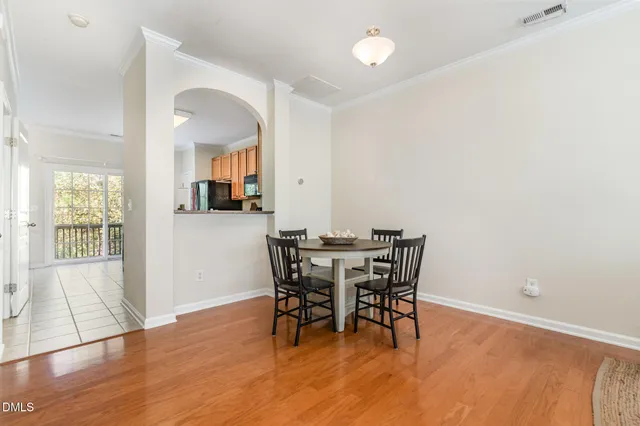 a view of a dining room with furniture and wooden floor