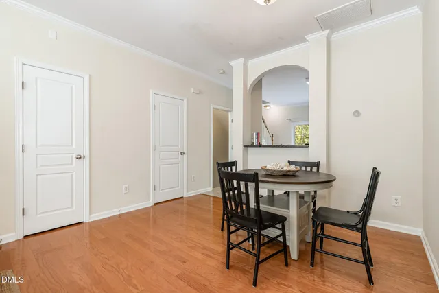 a view of a a dining room with furniture and wooden floor
