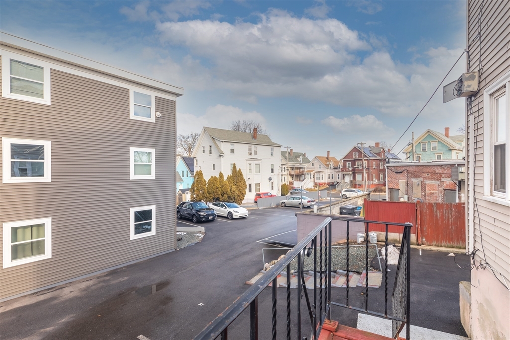 185 Lewis Street, Unit 4 Lynn, MA 01902 - Photo 18 of 20 a view of a chairs and table in a patio
