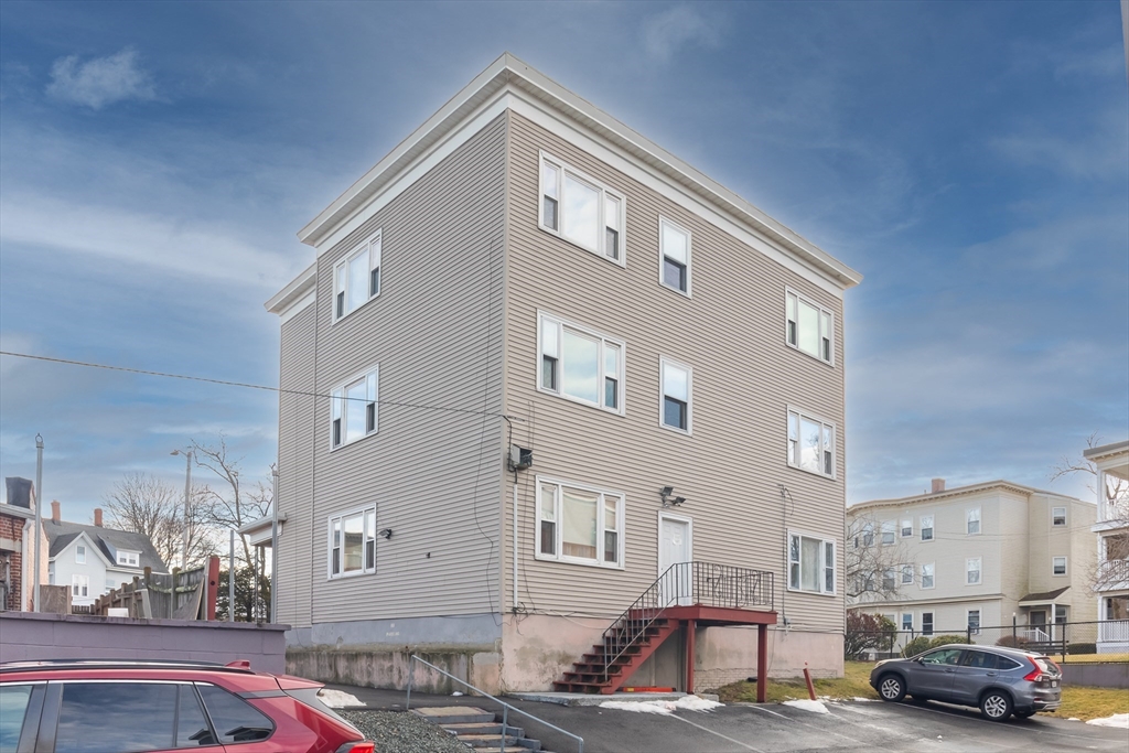 185 Lewis Street, Unit 4 Lynn, MA 01902 - Photo 19 of 20 a front view of a building with parking