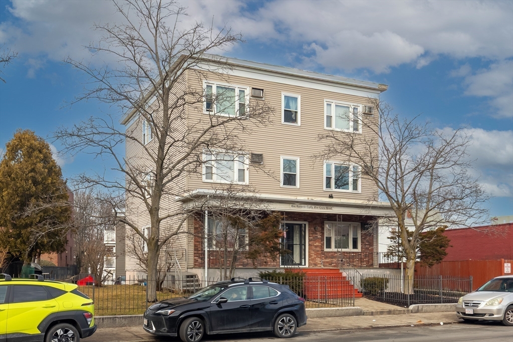 185 Lewis Street, Unit 4 Lynn, MA 01902 - Photo 2 of 20 a front view of a building with cars parked