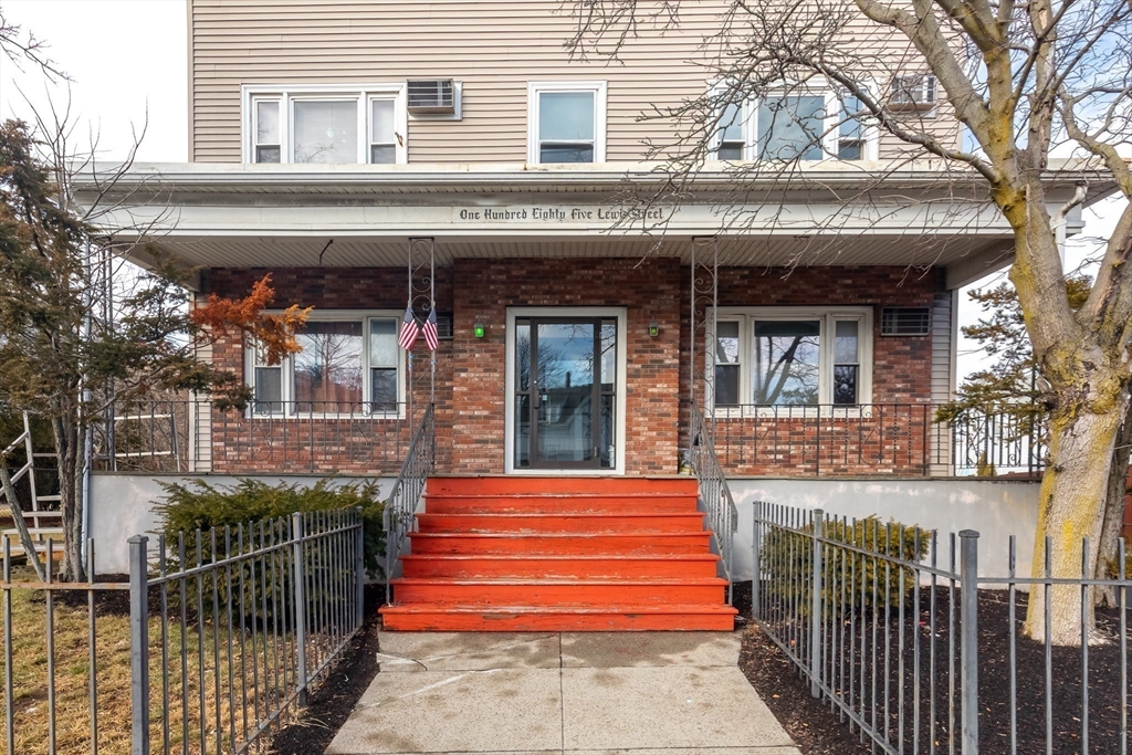 185 Lewis Street, Unit 4 Lynn, MA 01902 - Photo 3 of 20 a front view of a house with a porch