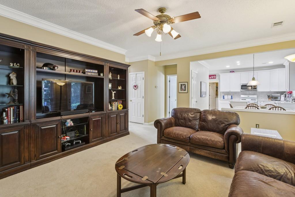 4815 Tanners Spring Drive Alpharetta, GA 30022 - Photo 11 of 45 a living room with furniture and a flat screen tv